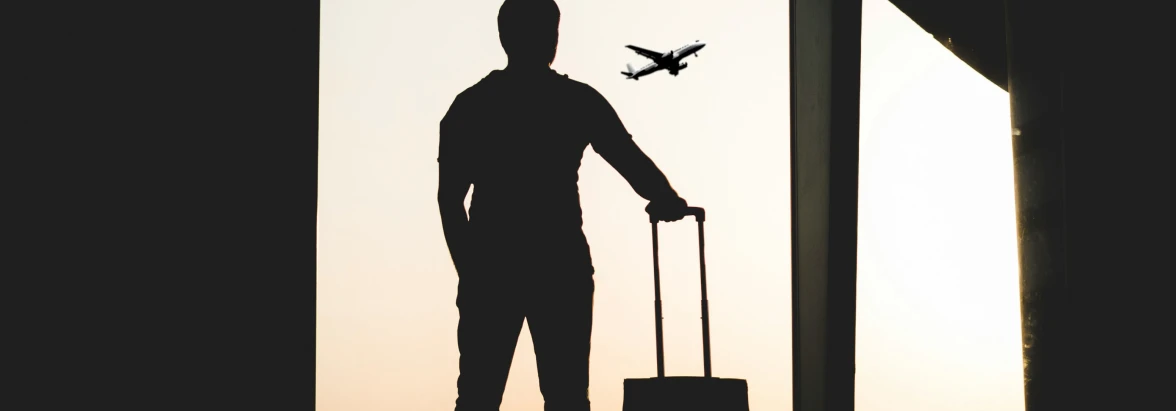 A Business Traveler stands in an Airport