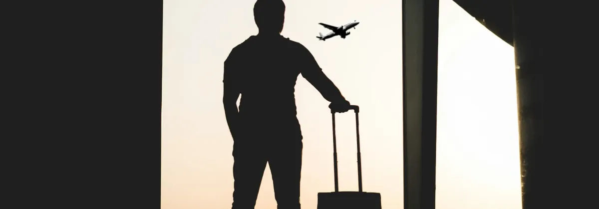 A Business Traveler stands in an Airport