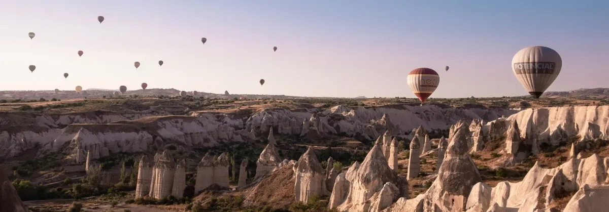 Hot Air Balloons Fly Over a Valley
