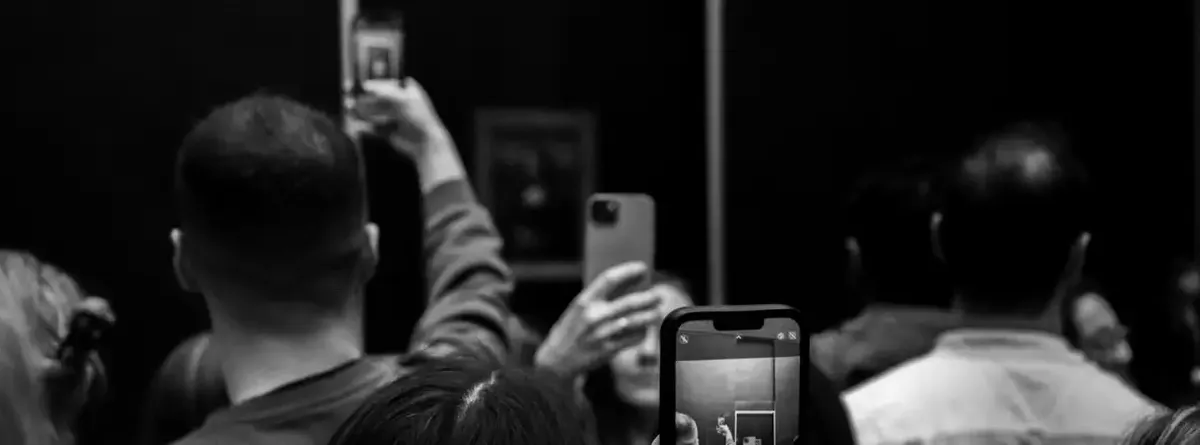 A crowd takes pictures on smartphones