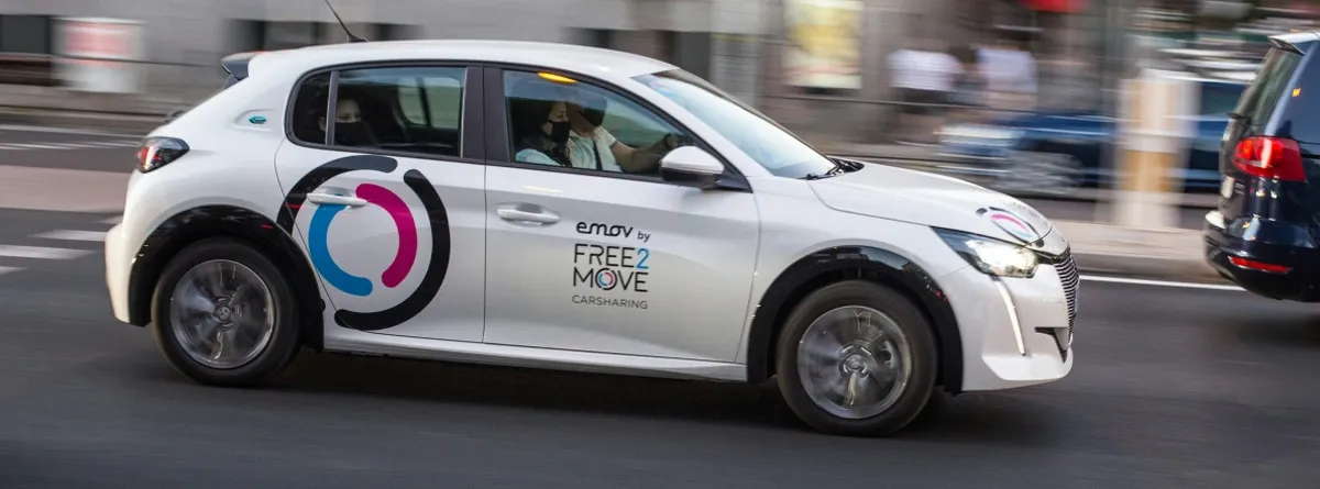 A Free2Move car driving through city traffic