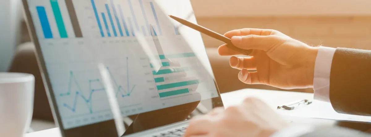 Compliance Checklist - businessman pointing with pen to a screen showing various charts