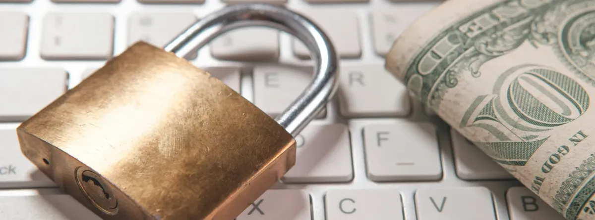 A Risk-Based Future - a padlock and One Dollar bill next to each other on a keyboard