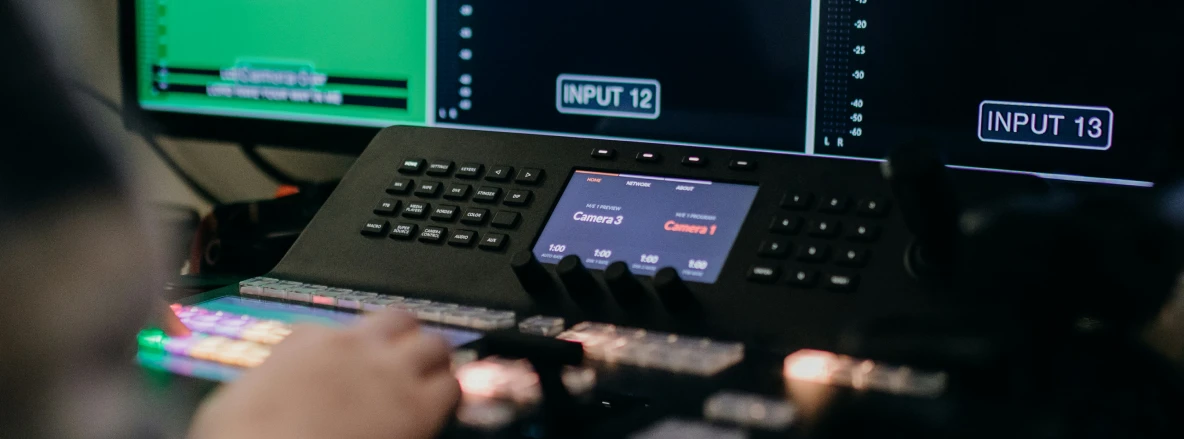 Mission Critical Connectivity -- a hand at the control station of a live TV center