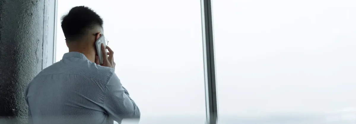 A back view of a person making a phone call