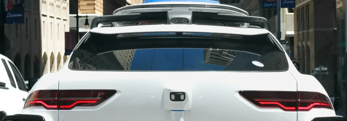 Rear view of a Waymo robotaxi, part of an IoT road safety strategy