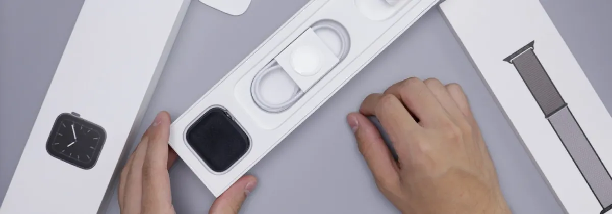 A person unboxing a new Apple Watch