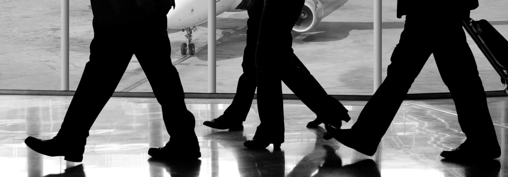 Top 5 Enterprise Trends 2026 - Business travelers walking through an airport terminal
