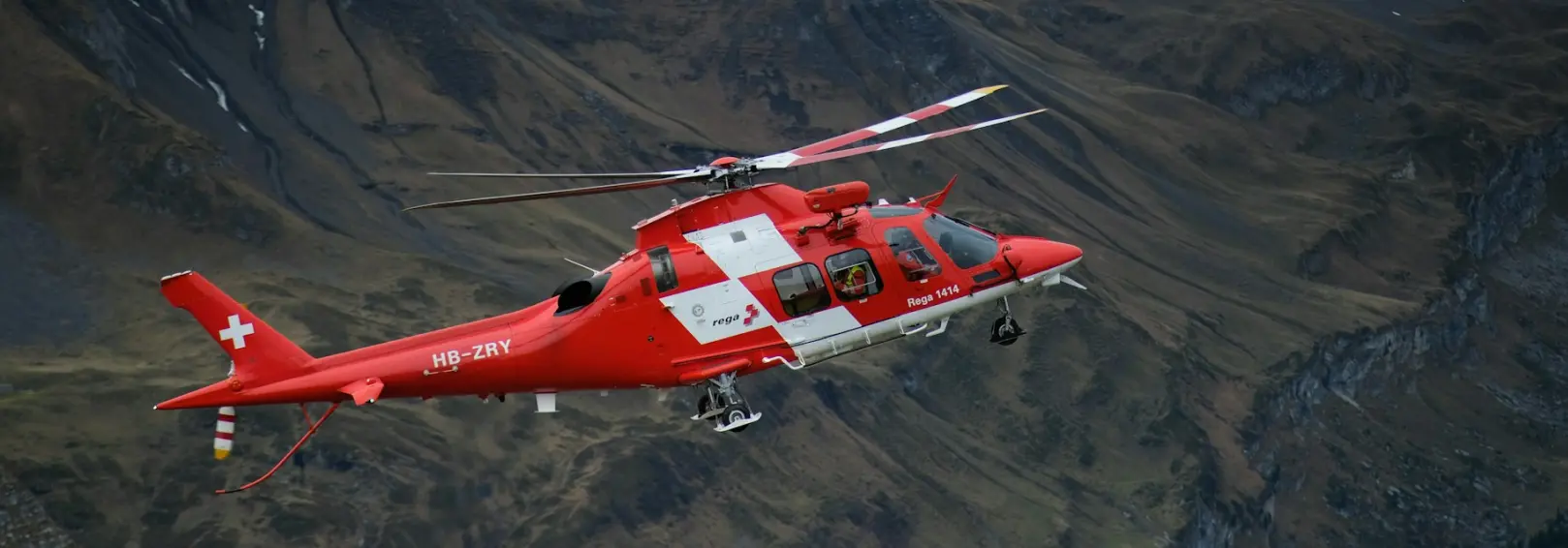 A medical helicopter over a mountainous landscape