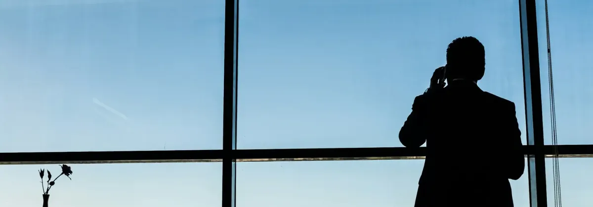 A silhouette of a person on making a phone call