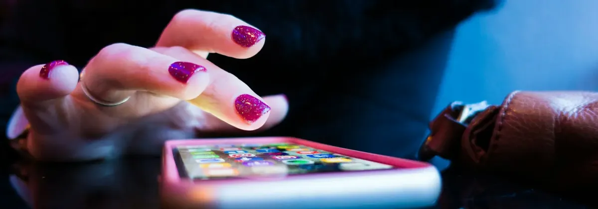 A hand hovers over a smartphone screen