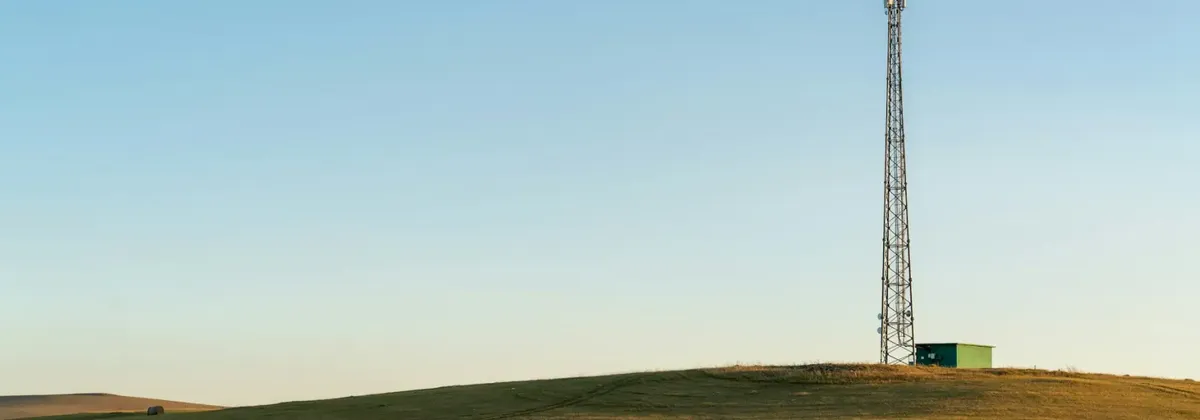 MNOs, MVNOs, explained - a mobile mast against a blue sky