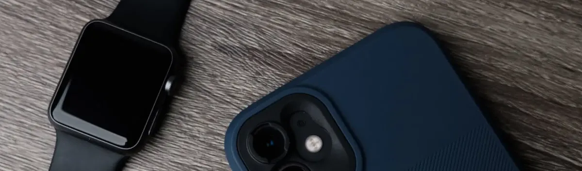 A smartwatch and a phone on a wooden surface - DPA allows for simple SIM provisioning to both devices