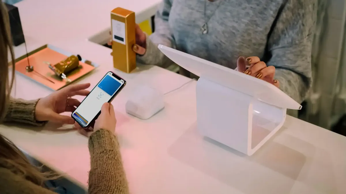 A person using a wireless POS system with SafeRetail POS connectivity