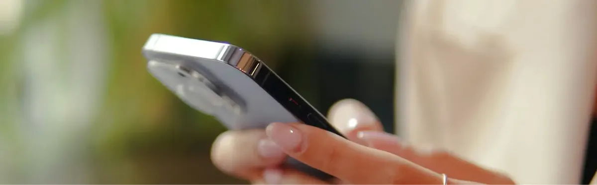 A person using a phone with an eSIM outside - Mobile World Live Industry Survey 2025