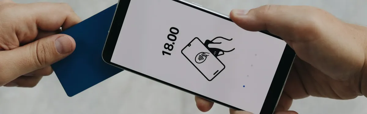 A person paying for something on an iPhone mPOS system using the Apple Tap to Pay function