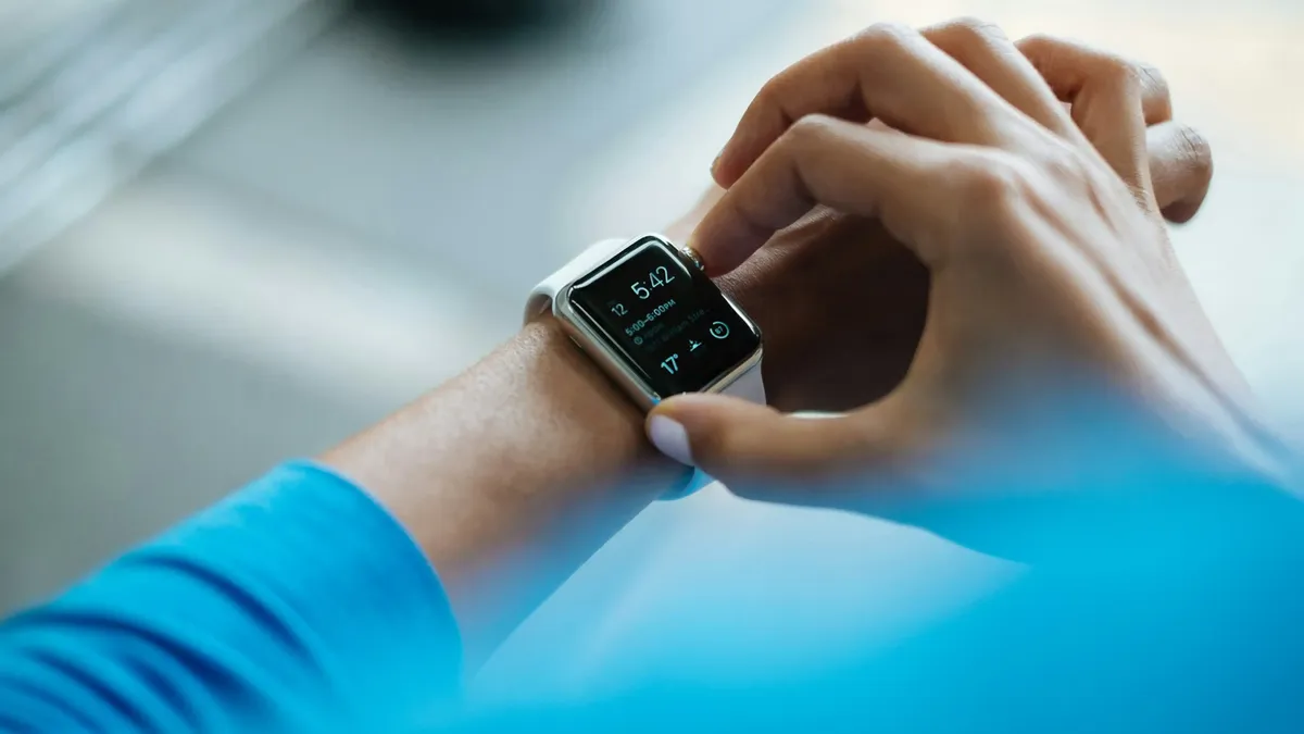 A person using a smartwatch, connected via an eSIM