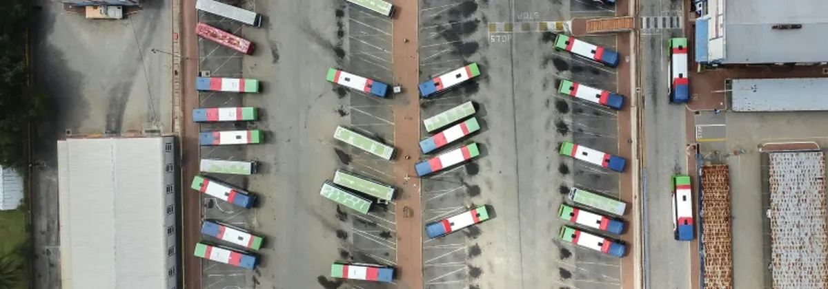 Unlocking IoT with SGP.32 - aerial view of a fleet of buses in a parking lot
