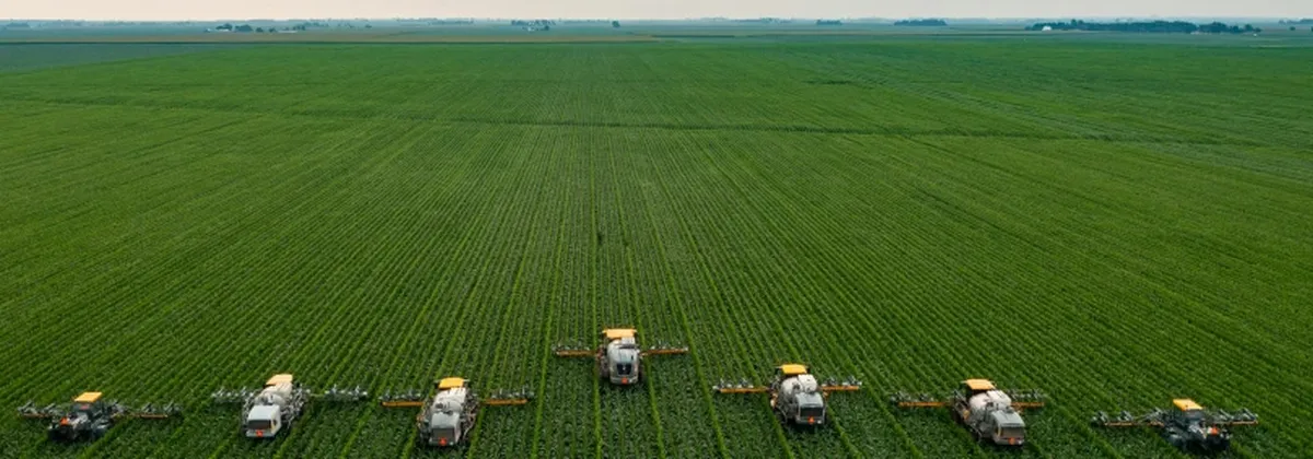 IoT and the Future of Farming - harvesters in a row working a green field