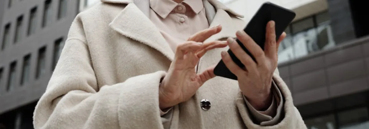 A person using a mobile phone to write business communications