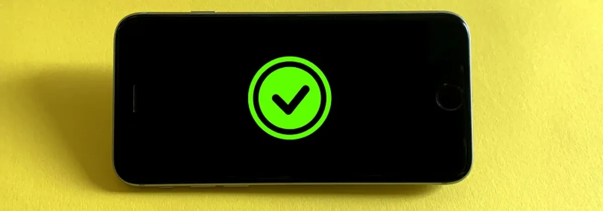 RSP Security - a mobile phone against a yellow background displaying a green tick on screen
