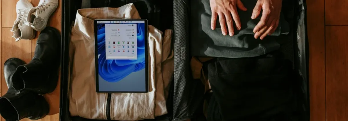 SmartEnterprise Connectivity Solutions - packing a suitcase with clothes and an iPad