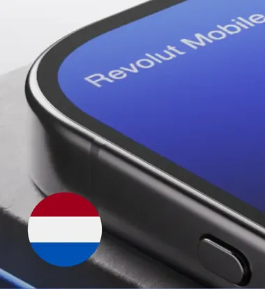 Close up image of a phone with Revolut network carrier with Netherlands flag icon.
